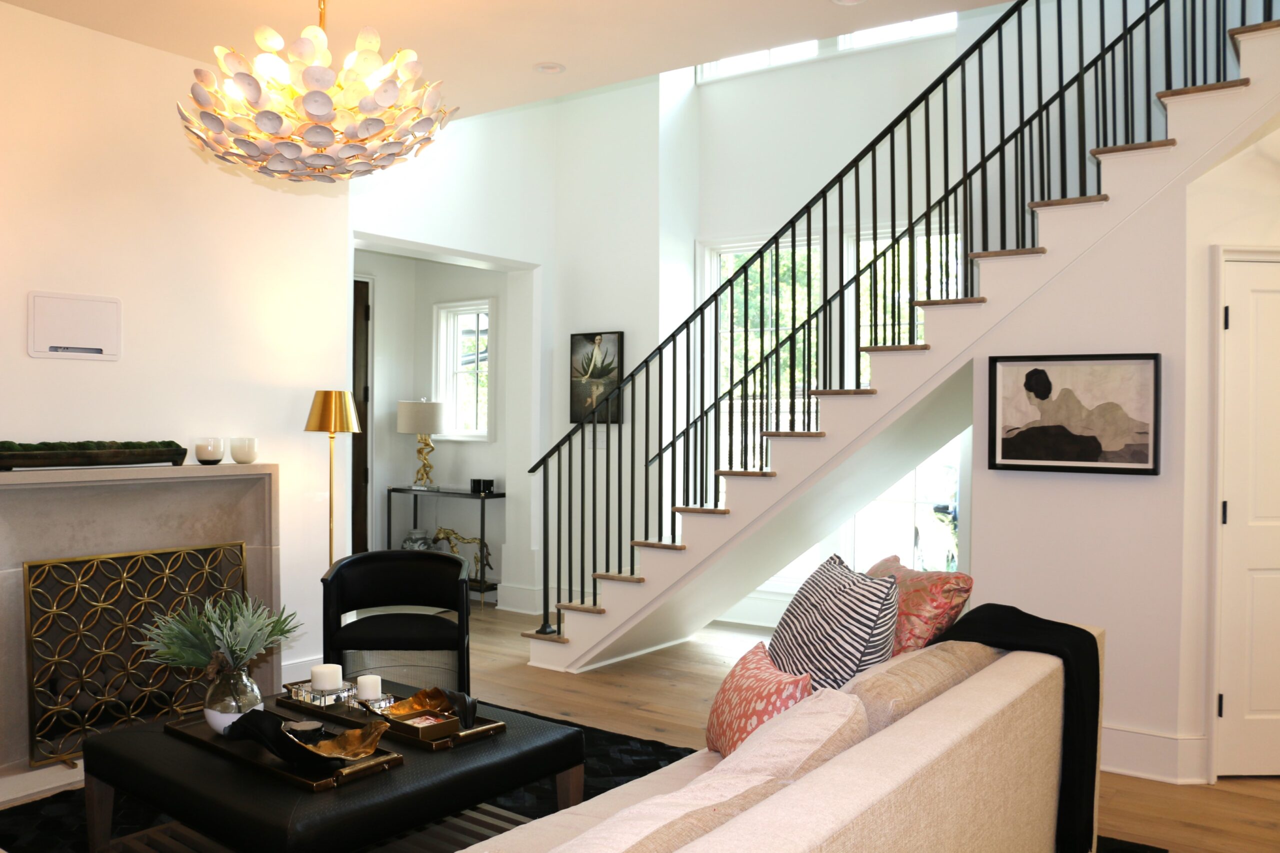 A modern staircase design featuring a spiral staircase and ornate metal railing.